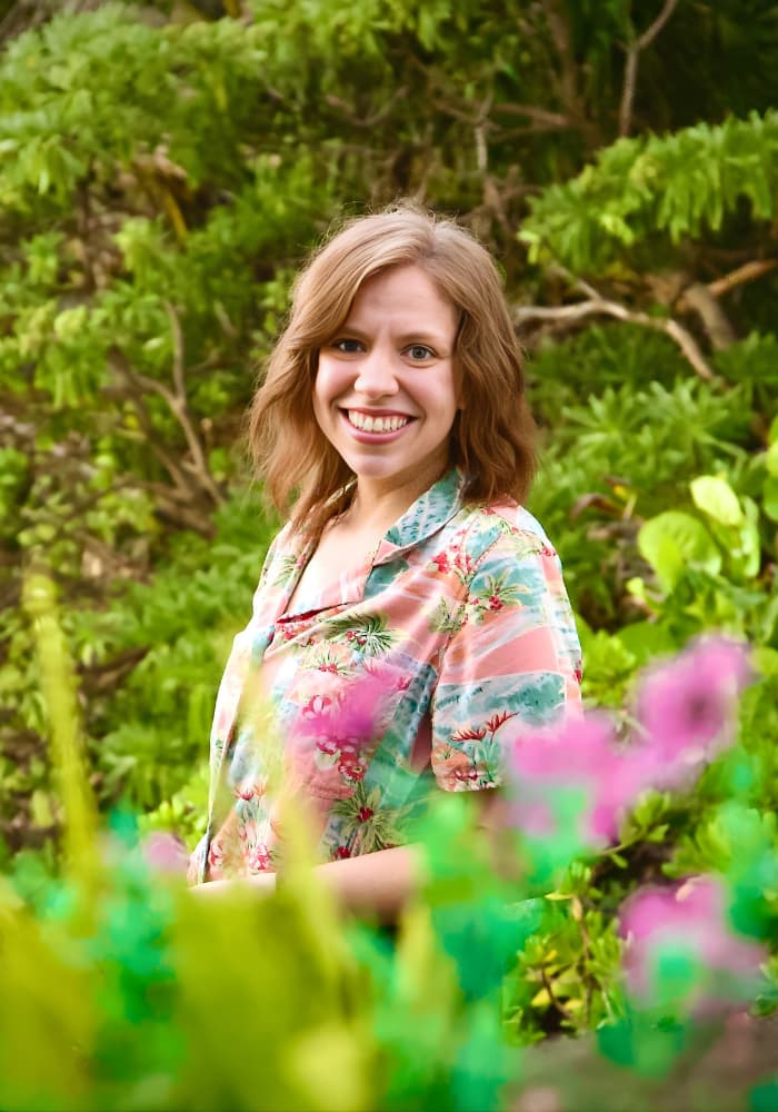 Katie Christensen standing in a green garden